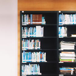 Multi colored books in shelf