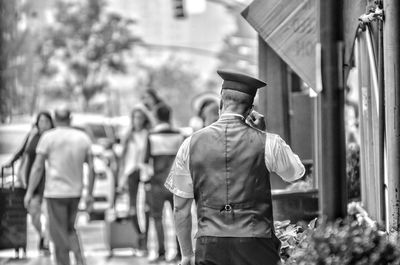 Rear view of people walking in city