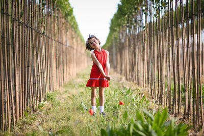 Portrait of smiling girl standing on field