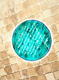 High angle view of manhole on sidewalk