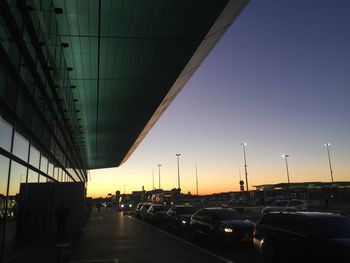 Cars on road in city against sky