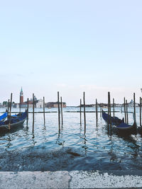 Boats in sea against clear sky