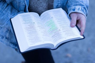Close-up of hand holding book