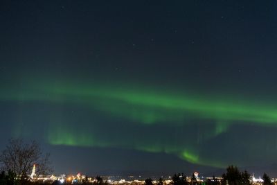 Illuminated cityscape against sky at night