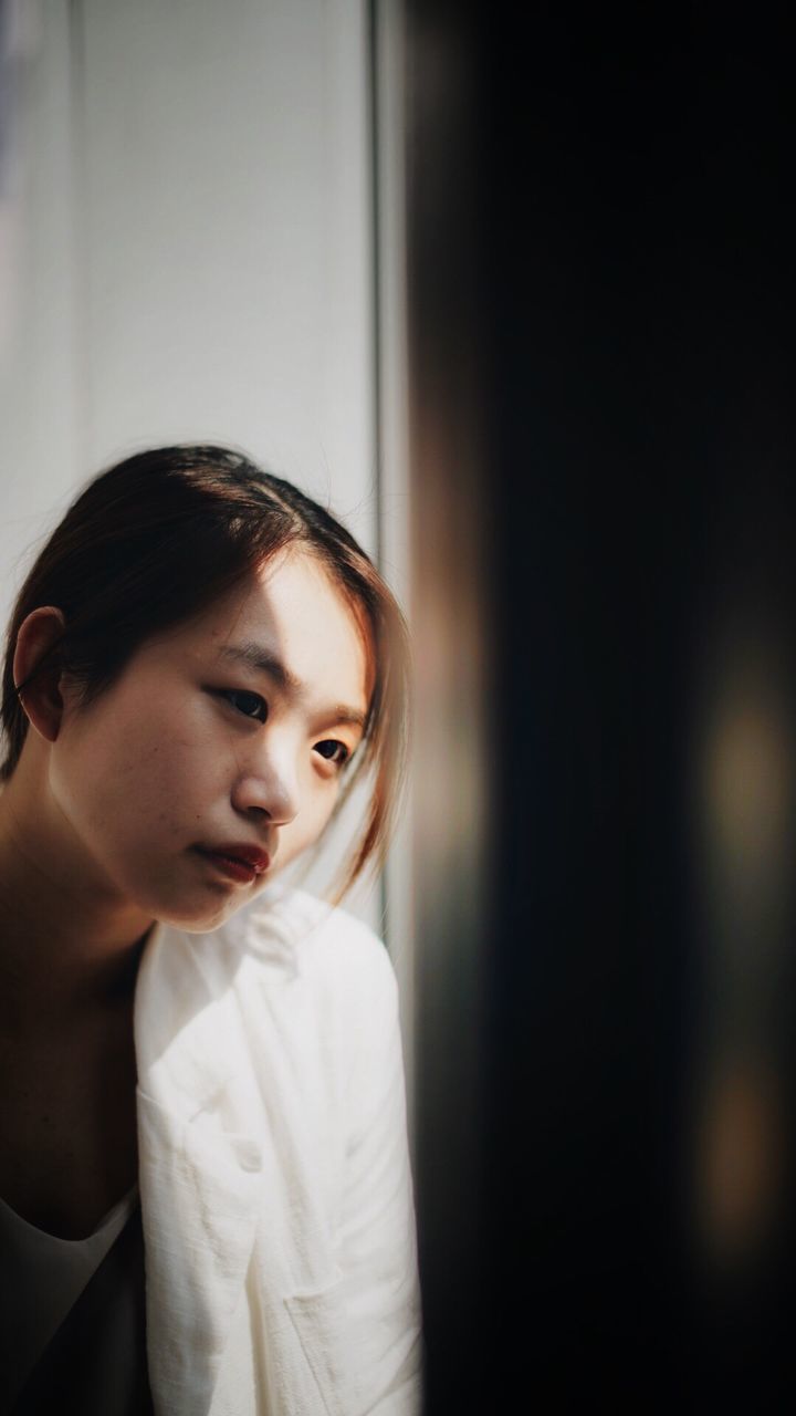 PORTRAIT OF A GIRL LOOKING AWAY WHILE STANDING IN HAIR