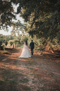 Rear view of married couple walking outdoors