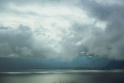 Scenic view of sea against storm clouds