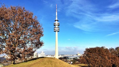 Low angle view of communications tower in city