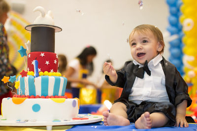 High angle view of cute boy sitting on table