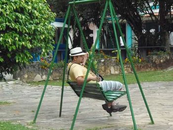 Full length of girl sitting on bench