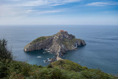 High angle view of rocks in sea against sky