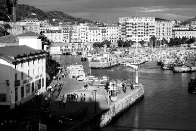 Boats moored at harbor in city