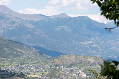 Aerial view of townscape against mountains