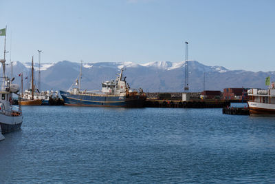 Boats moored at harbor