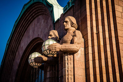 Low angle view of statue against building