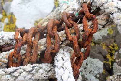 Close-up of rusty rope on rock