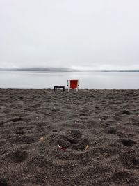 Lifeguard hut on beach against sky