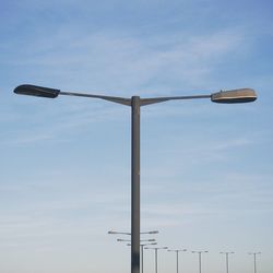 Low angle view of street light against cloudy sky