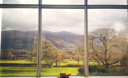 Scenic view of mountains against cloudy sky