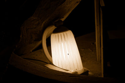 Close-up of illuminated lamp in darkroom