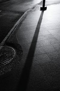 Low section of shadow on floor