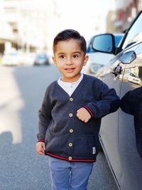 Portrait of young man standing in city