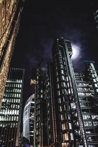 Low angle view of buildings against sky at night