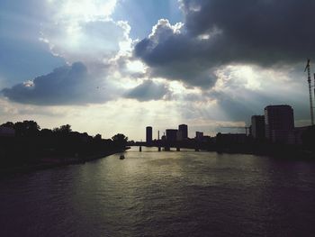 City by river against sky