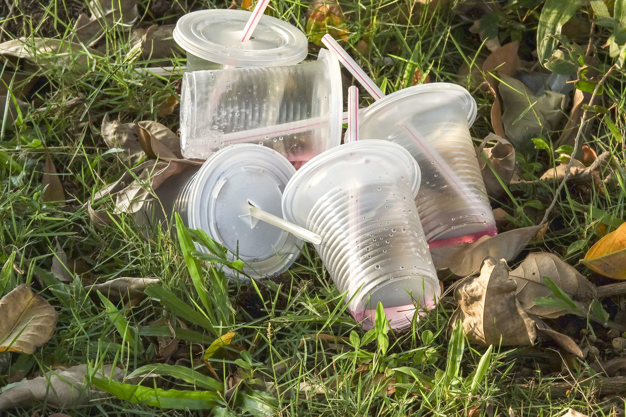 HIGH ANGLE VIEW OF BOTTLE ON FIELD