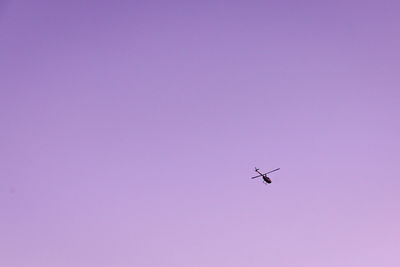 Low angle view of helicopter flying in sky