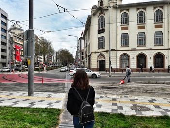 Rear view of woman standing in city