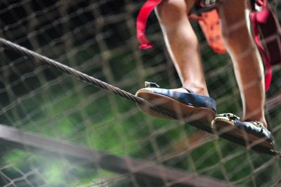 Low section of girl walking on tightrope