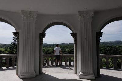Rear view of man and woman in historic building