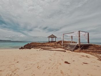 Lifeguard hut on beach against sky