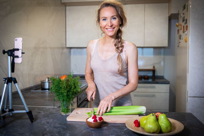 Happy woman preparing food at home