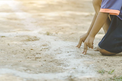 Low section of boy playing on field