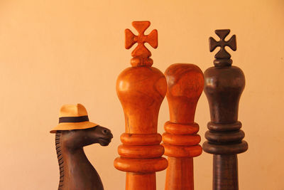 Close up of wooden chess pieces against beige background