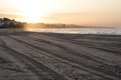 Scenic view of beach against sky during sunset