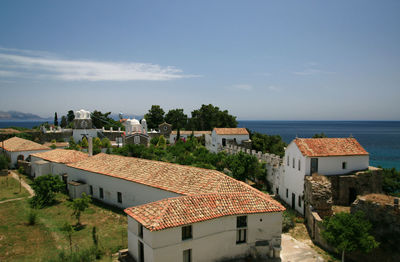 High angle view of townscape by sea against sky