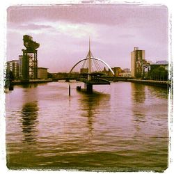 Bridge over river with city in background