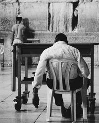 Rear view of man sitting in park