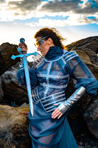 Low angle view of woman standing on rock