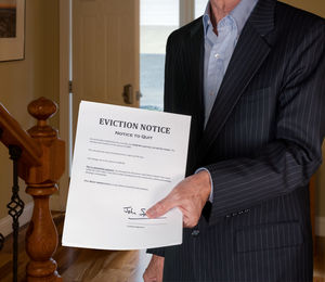 Midsection of man holding paper at home
