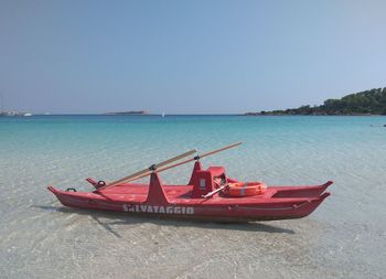 Fishing boat on sea against clear sky