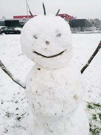 Close-up of snow on field against sky