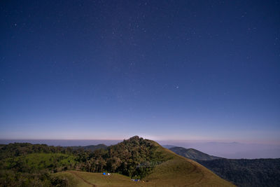 Scenic view of landscape against blue sky at night