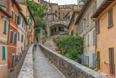 Footpath amidst buildings in city