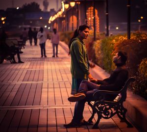 Couple sitting in city at night
