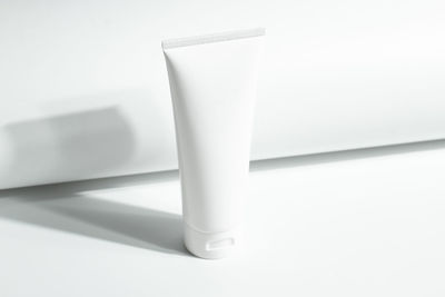 High angle view of squeeze tube over white background