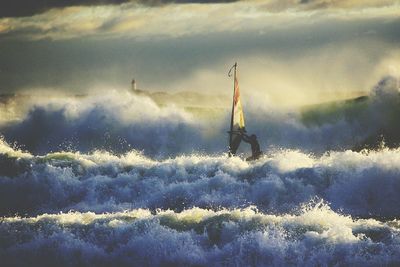 Boats in sea against sky